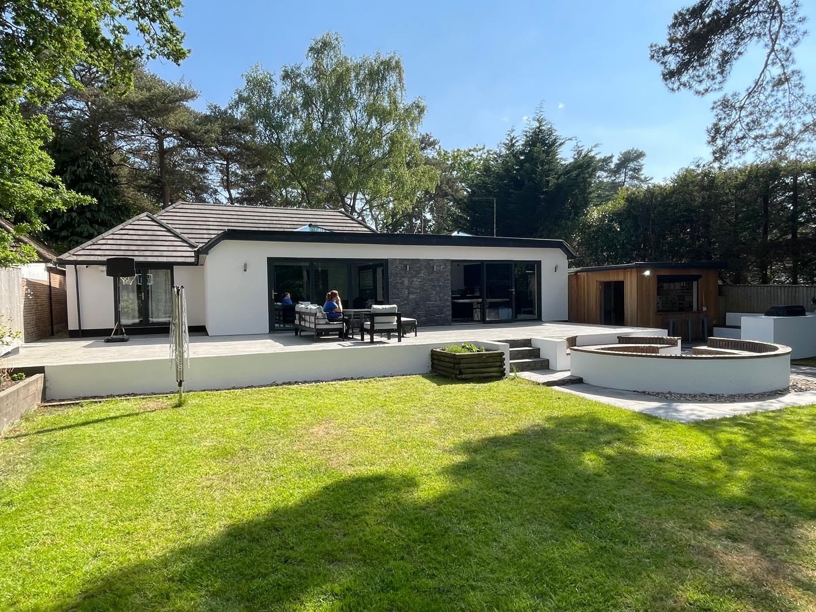 The back of Kiwi Pines, with a large terrace, outdoor seating and the garden bar